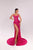 Woman wearing a pink evening gown with a high slit on a light gray background