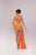 Woman wearing an orange strapless dress with a long train on a light gray background