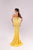 Woman wearing a yellow evening gown with a white background